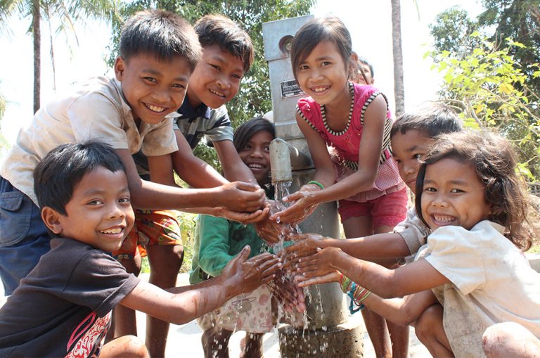 Children in Cambodia with a hand pump well